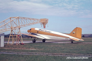 ZK-APK being loaded with fertiliser for topdressing, late 1970's. Photo: John Anderson.