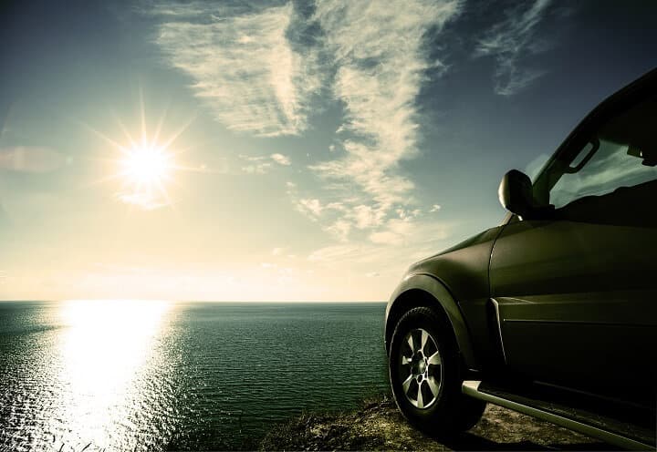 SUV Overlooking Sea Cliff